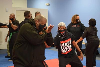 PACS students drilling self-defense techniques in a group class