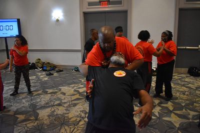 PACS instructor demonstrating a choke escape in a group seminar
